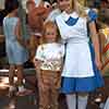 Alice in Wonderland in Disneyland Town Square with guest, June 1968